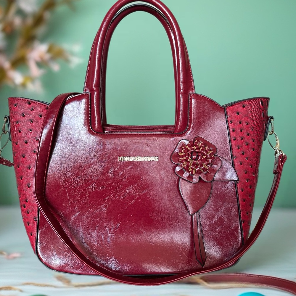 Elegant Red Handbag with Floral Accent. Michael Kors